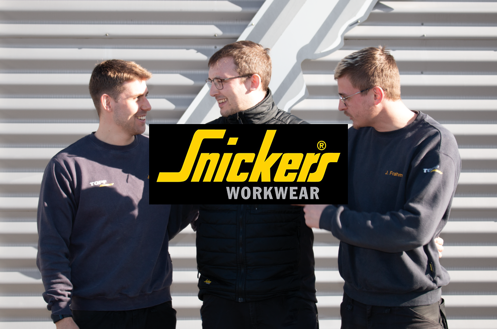 Mit Snickers Veredelung die Arbeitskleidung mit Firmenlogos bedrucken! Zum Service! Das Bild zeigt einen Teil des TOPF-Teams mit bedruckter Snickers Arbeitskleidung